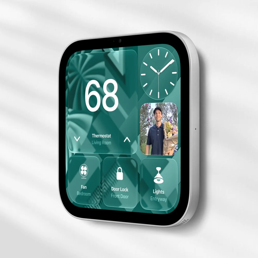 Wall-mounted Apple HomeView displaying thermostat, door lock, lights and camera controls.
