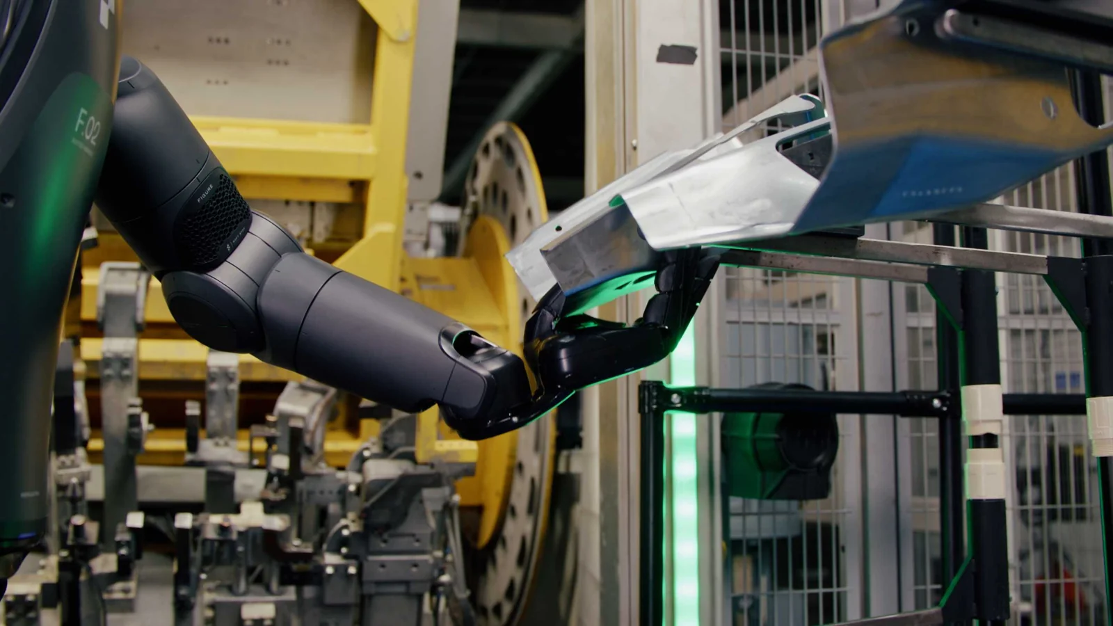 Close-up of Figure 02’s robotic hand handling a metal component at BMW’s Spartanburg plant.