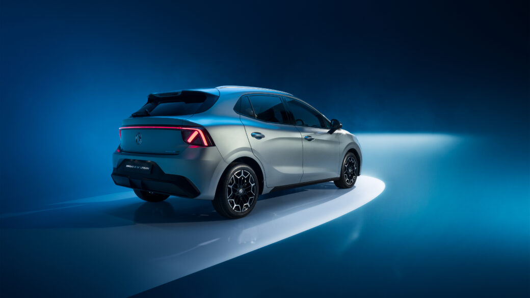 Rear three-quarter view of a silver MG4 EV Urban against a studio background in MG Motor Europe’s official imagery; overseas specification
